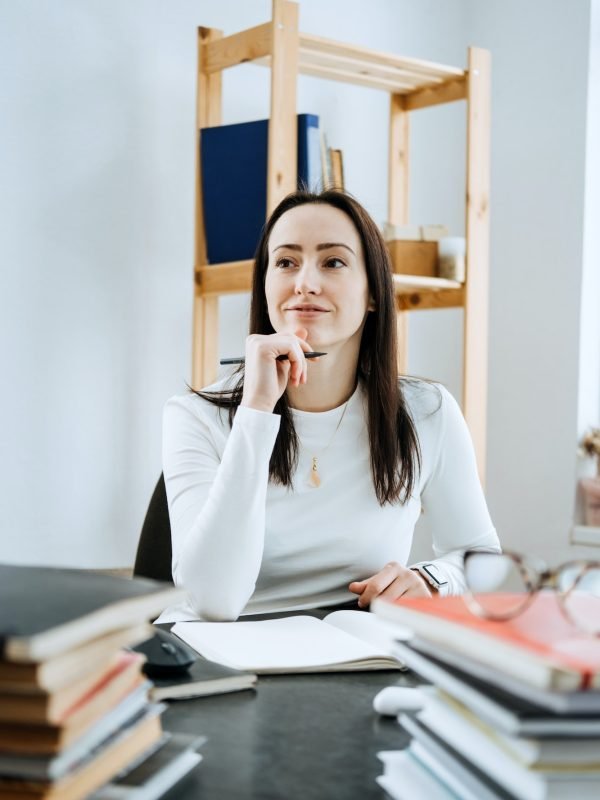 Account balance definition. Female Accountant working with many books and notepads