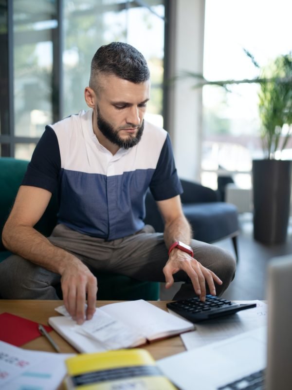 Businessman feeling involved in calculations and accounting