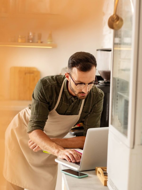Businessman doing bookkeeping while owning coffee shop