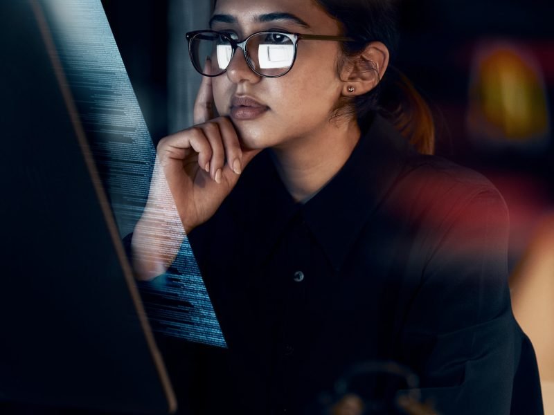 Programming, cybersecurity and thinking with woman at computer for software, idea and coding at nig