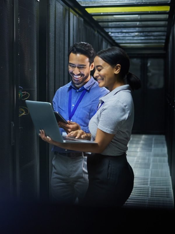 Server room, laptop and technician people for software management, system upgrade or cyber security