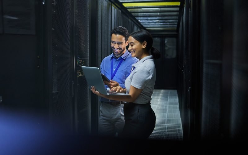 Server room, laptop and technician people for software management, system upgrade or cyber security