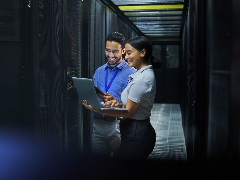 Server room, laptop and technician people for software management, system upgrade or cyber security