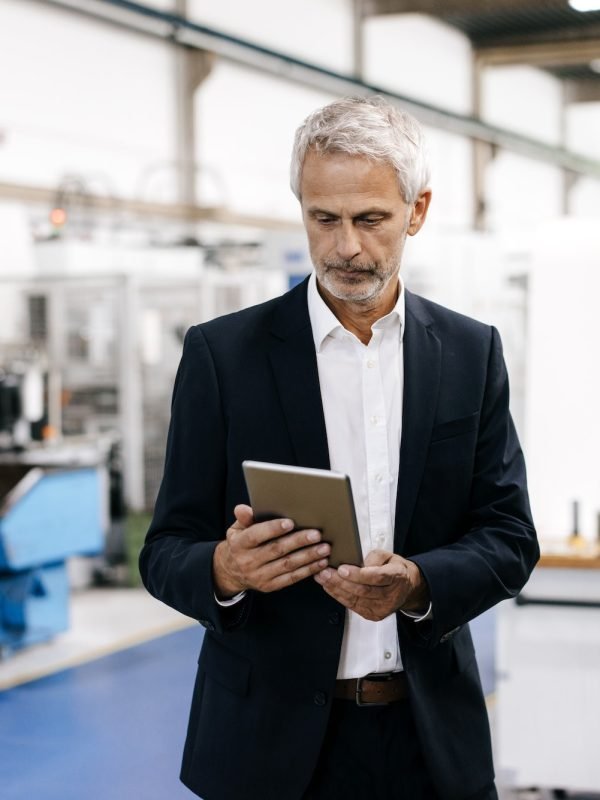 Manager using digital tablet in high tech company