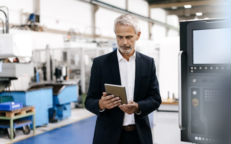 Manager using digital tablet in high tech company Manager using digital tablet in high tech company