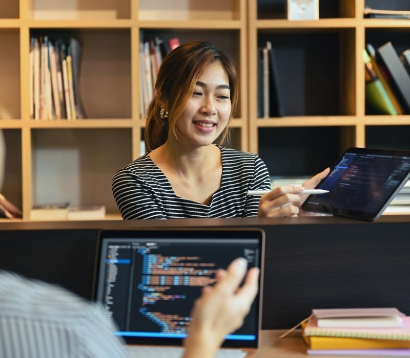 Team of professional programmers brainstorming ideas for website interface development.