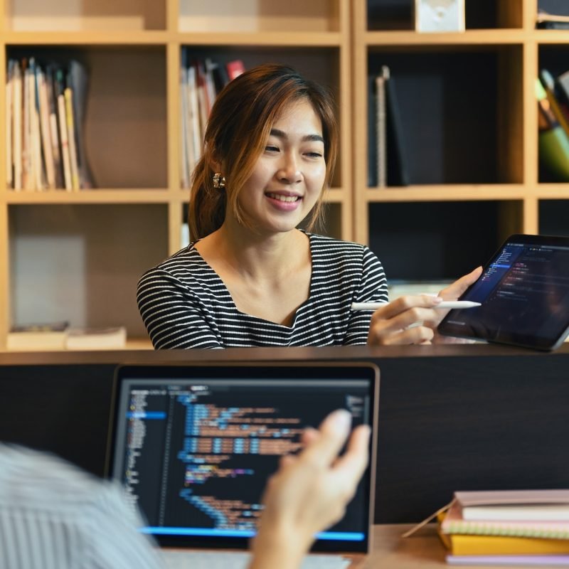 Team of professional programmers brainstorming ideas for website interface development.