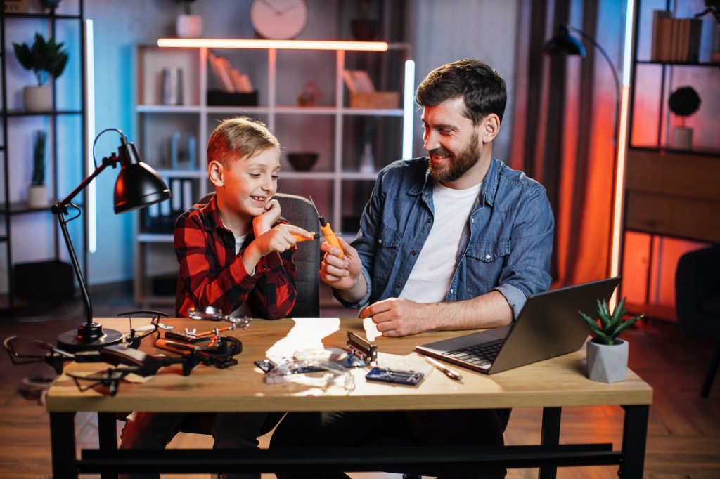 Father with son repairing electronics in game form