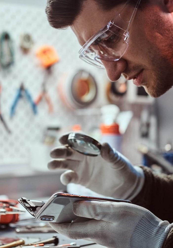 electronic-technician-repair-damaged-smartphone-in-the-workshop