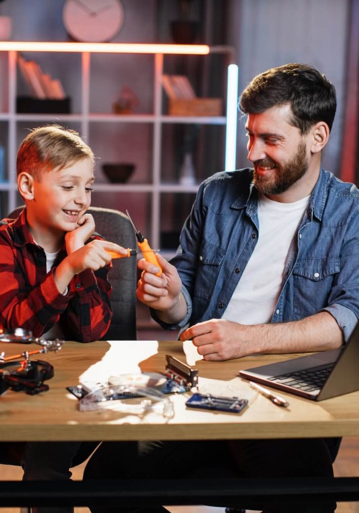 father-with-son-repairing-electronics-in-game-form