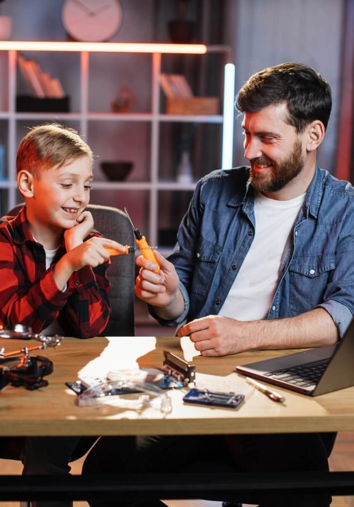 father-with-son-repairing-electronics-in-game-form