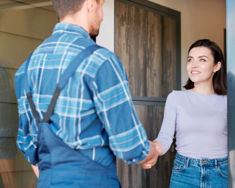 happy-young-client-of-maintenance-service-shaking-hand-of-technician