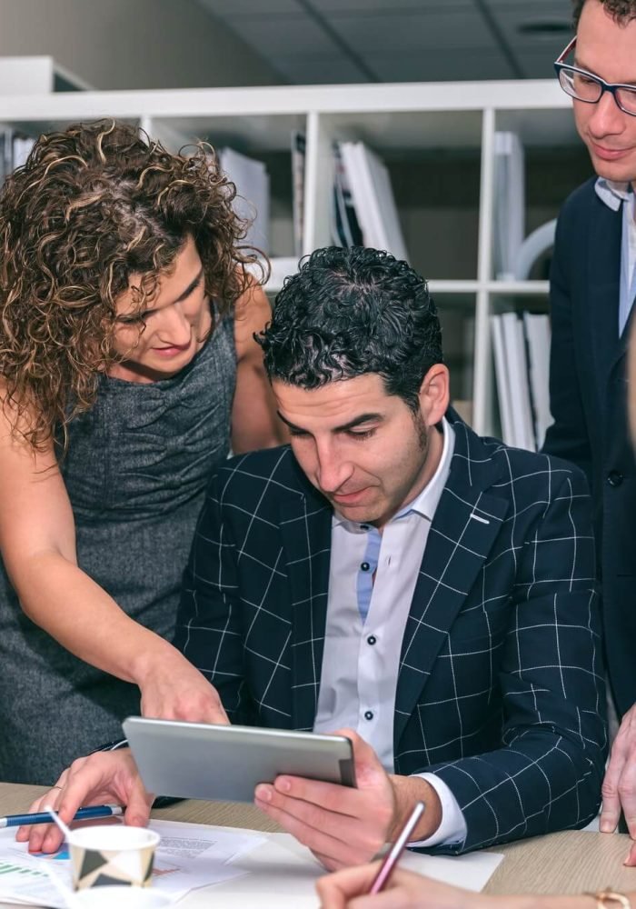 teamwork-looking-business-document-in-electronic-tablet