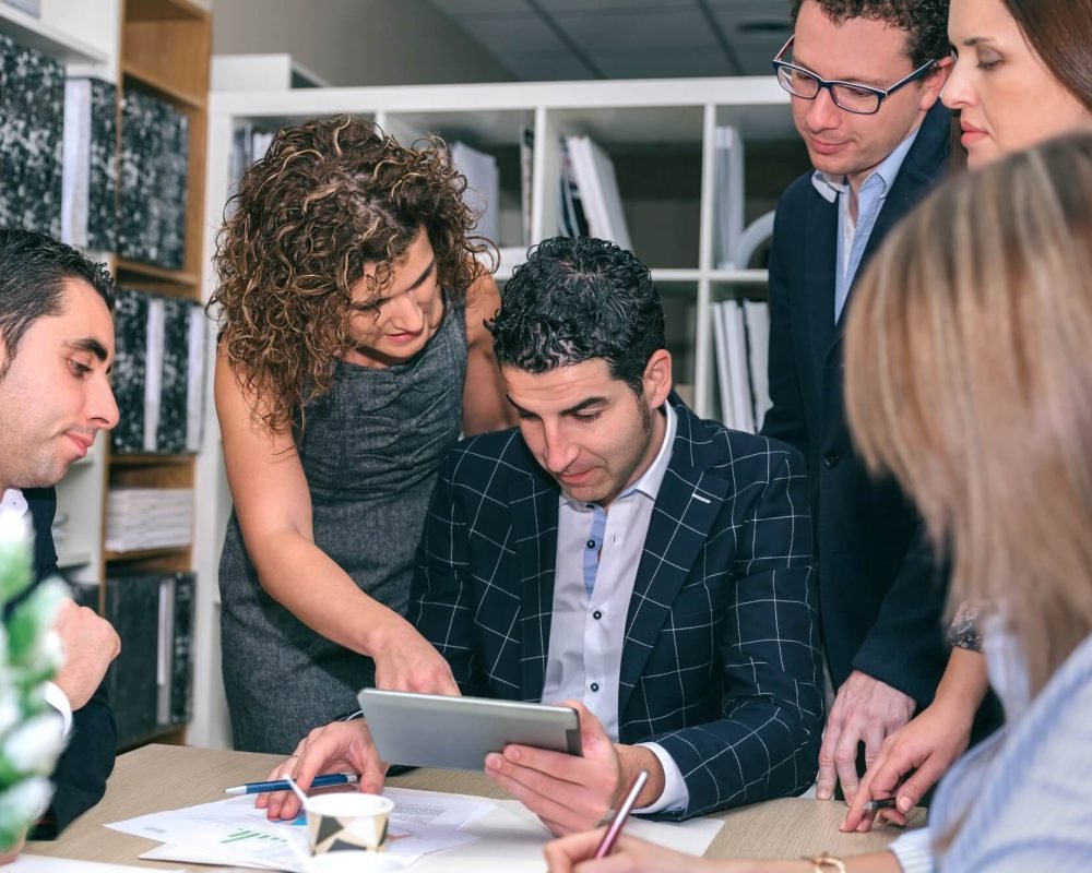 teamwork-looking-business-document-in-electronic-tablet
