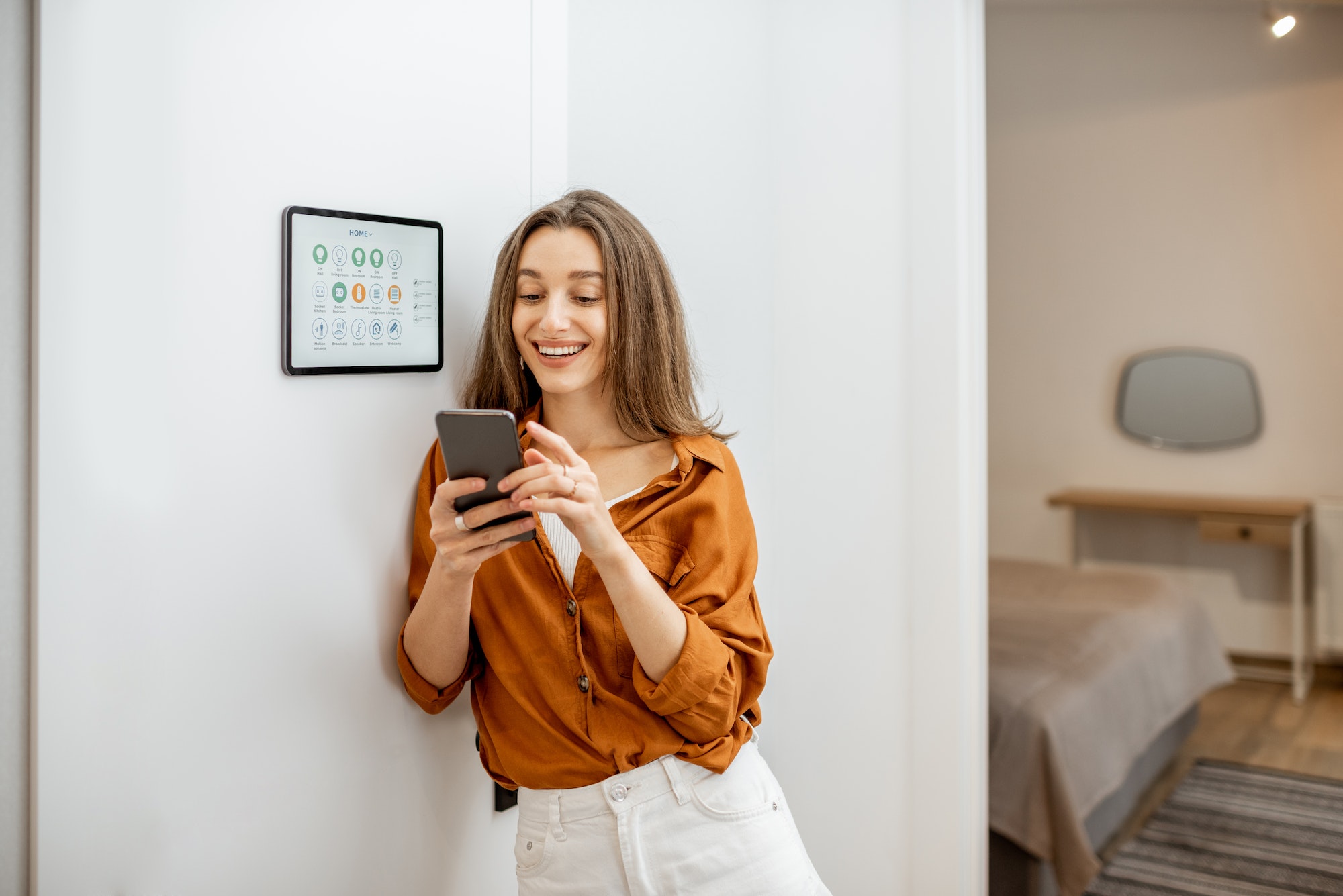 Portrait of a happy woman controlling smart home