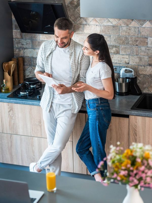 married-couple-using-digital-tablet-together-in-kitchen-smart-home-concept