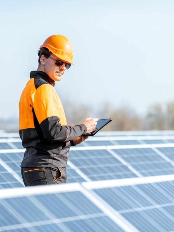 Engineer servicing solar panel on electric plant