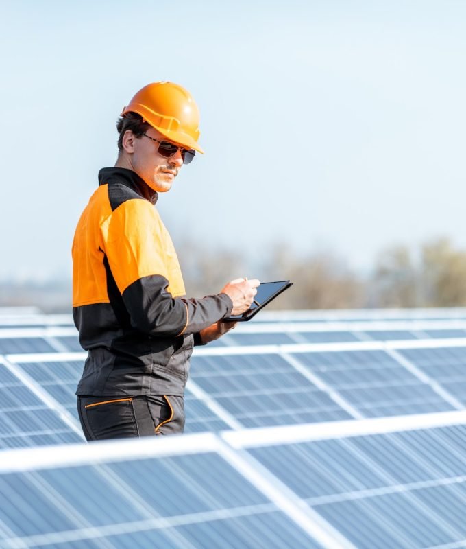 Engineer servicing solar panel on electric plant