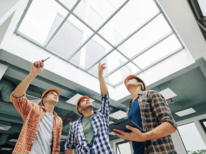 engineers-discussing-old-massive-roof-window