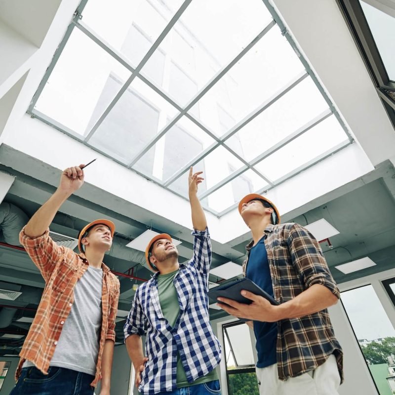 engineers-discussing-old-massive-roof-window