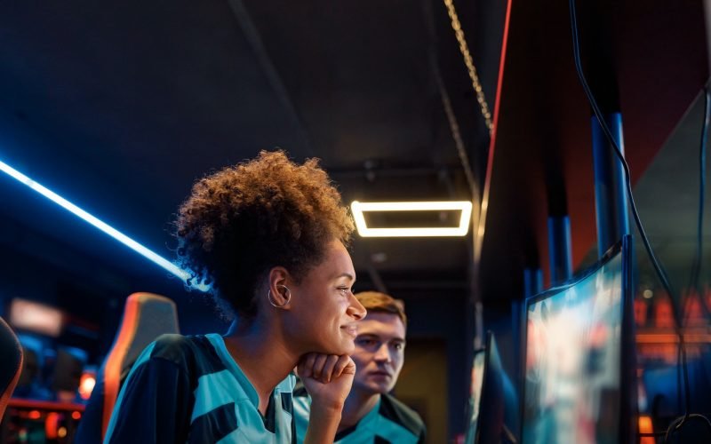 African professional gamer playing important match in cyber club