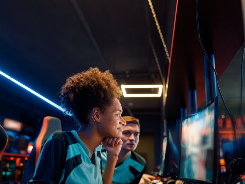 African professional gamer playing important match in cyber club