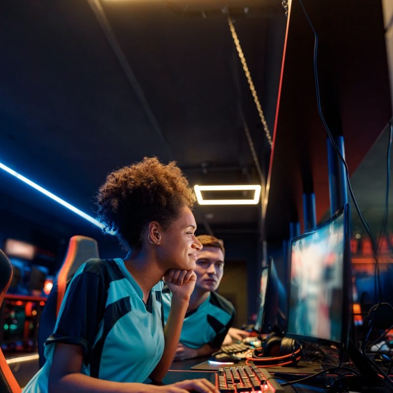 African professional gamer playing important match in cyber club