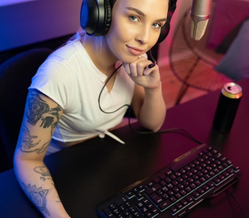 E-sport gamer girl live streaming and plays online video game on PC