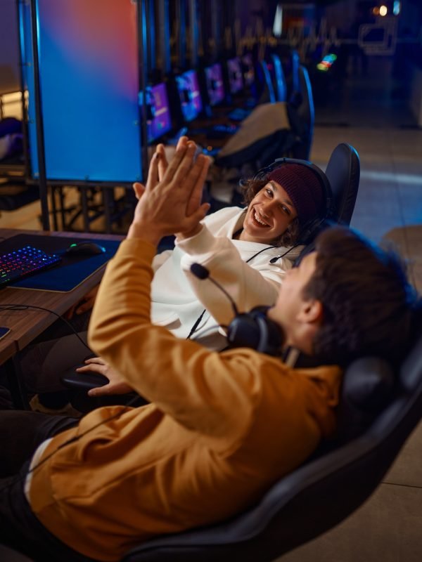 Two young gamers having fun in game club