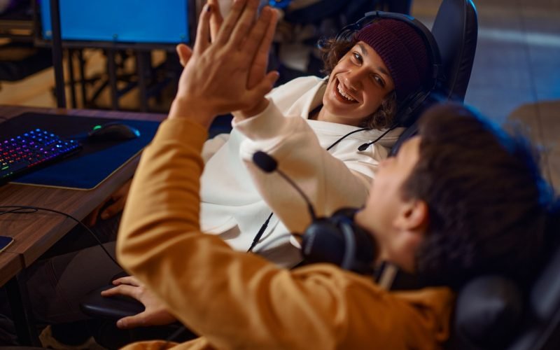 Two young gamers having fun in game club