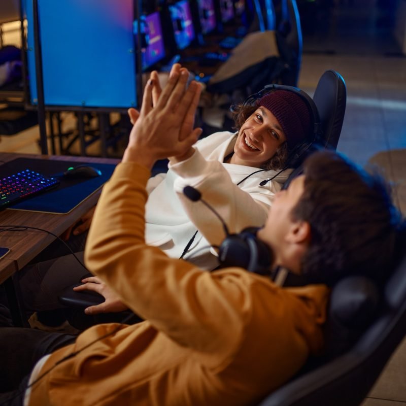 Two young gamers having fun in game club