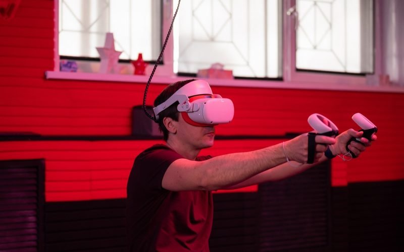 vr game and virtual reality. adult man gamer in 3d glasses playing on shooting simulation video game