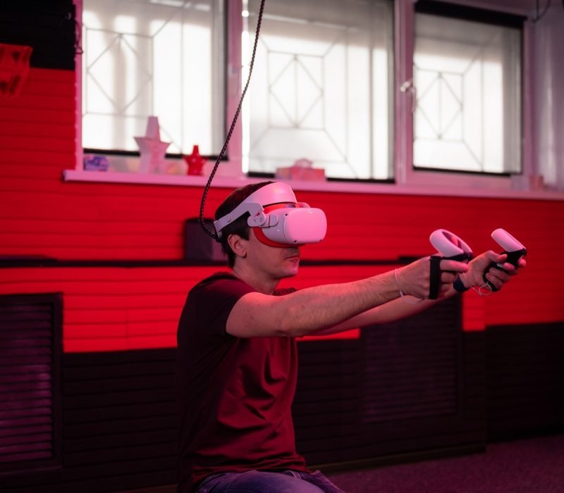 vr game and virtual reality. adult man gamer in 3d glasses playing on shooting simulation video game