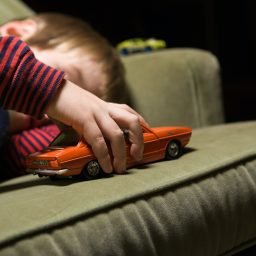 Boy playing with a toy car