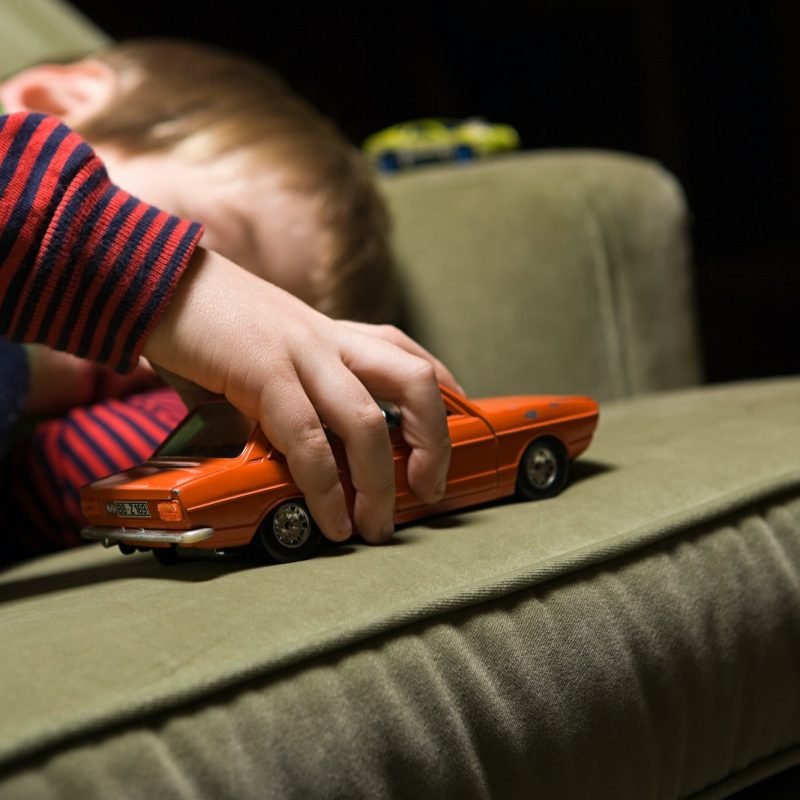 Boy playing with a toy car