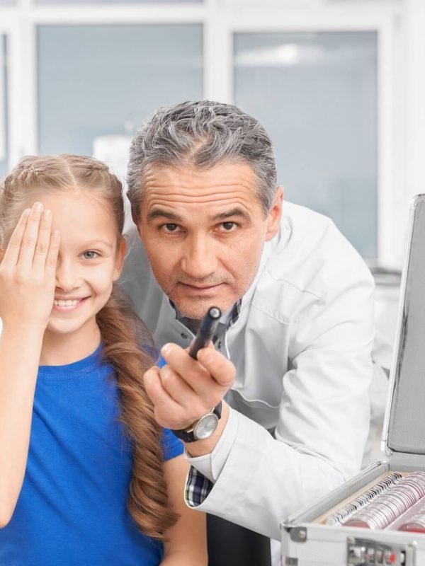 girl-closing-eye-with-hands-and-looking-at-camera-in-clinic