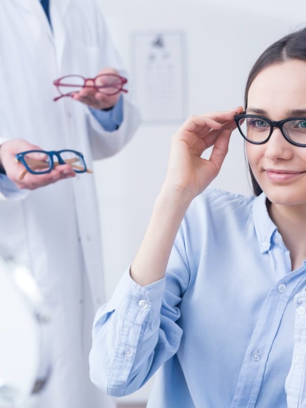 Optician with eyeglasses and client