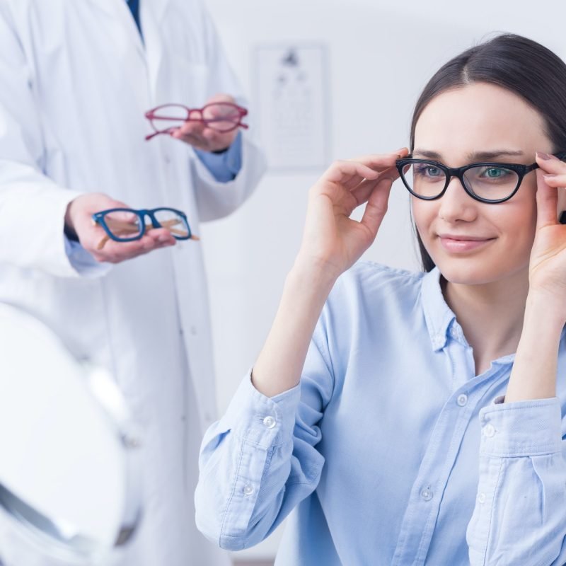 Optician with eyeglasses and client