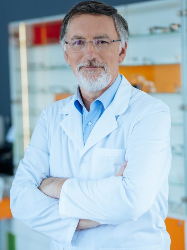 Positive nice professional optician standing cross handed