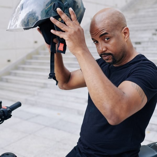 Mixed-race man sitting on bicycle