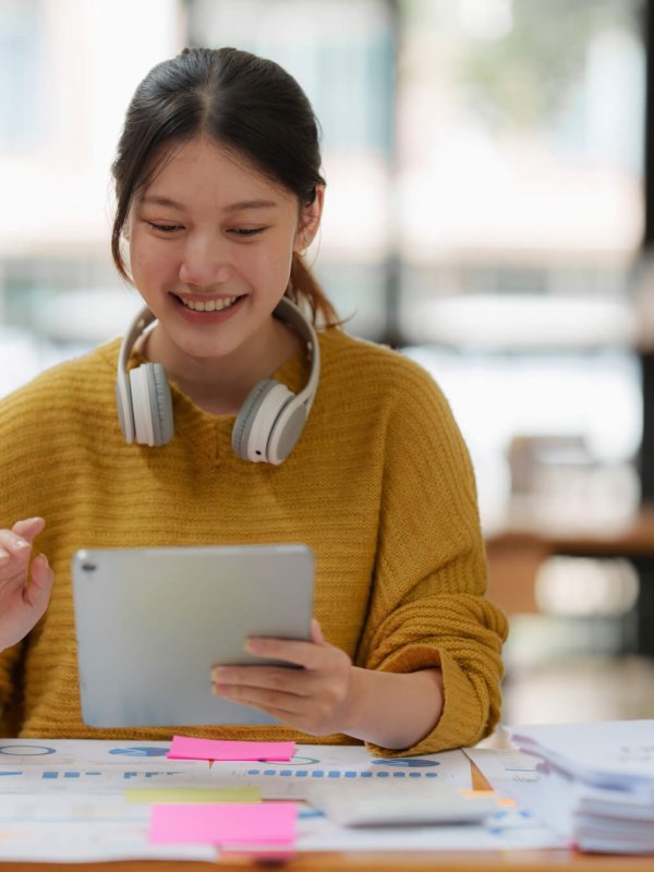 Attractive female student learning language, watching online webinar, listening audio course, e