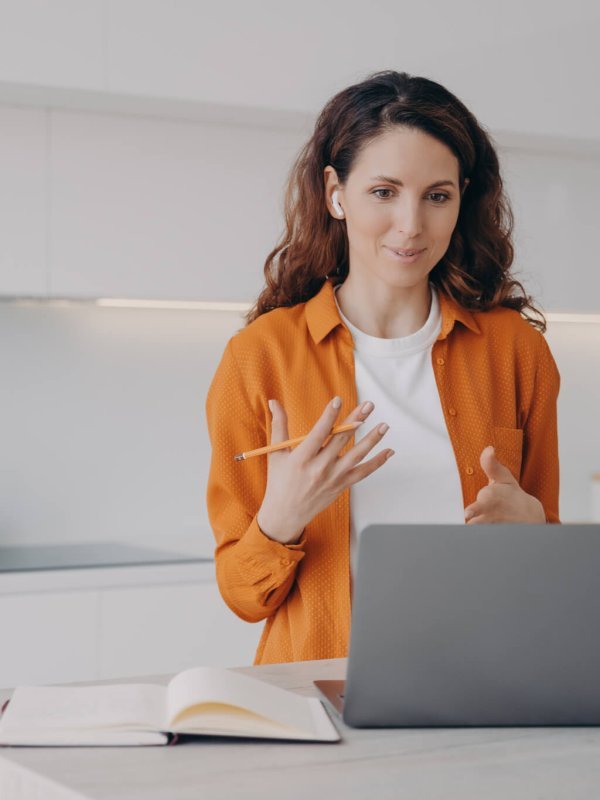 Tutor has lesson online on computer. Young pretty woman teaching students language online.