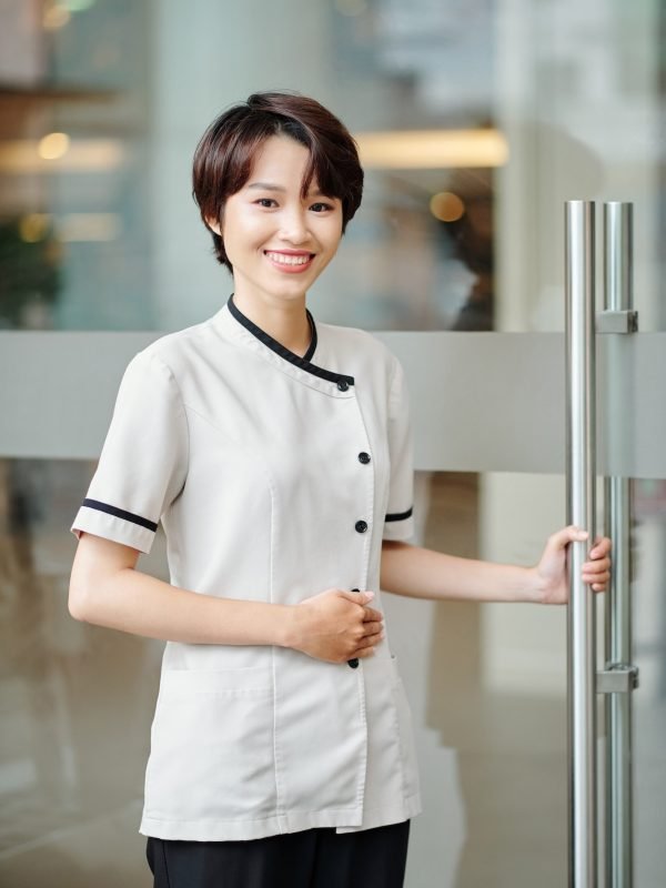 Cheerful Asian hotel manager