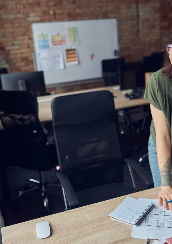 interior-designer-or-architect-in-casual-wear-with-messy-hairdo-smiling-aside-while-working-on-a