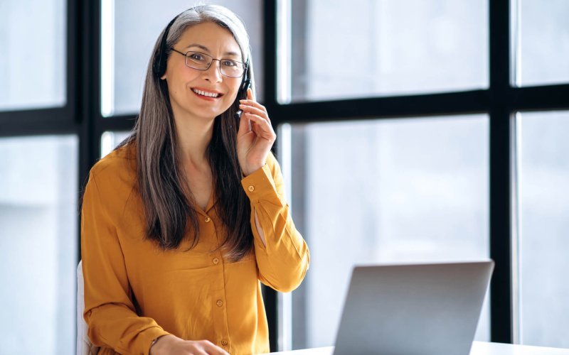 asian woman business online meeting virtual laptop mature