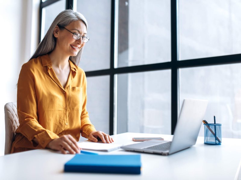 asian woman business online meeting virtual laptop mature