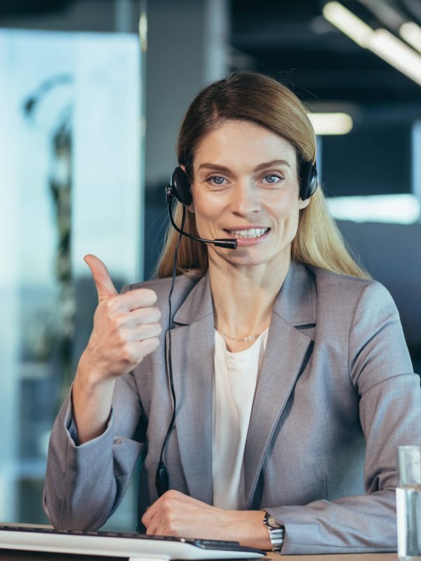 Portrait of woman with headset, call center employee smiling and happy talking
