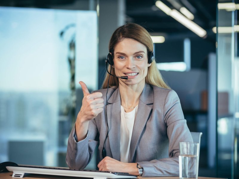 Portrait of woman with headset, call center employee smiling and happy talking