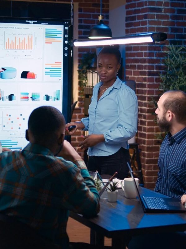 Diverse women coaching company team in business meeting