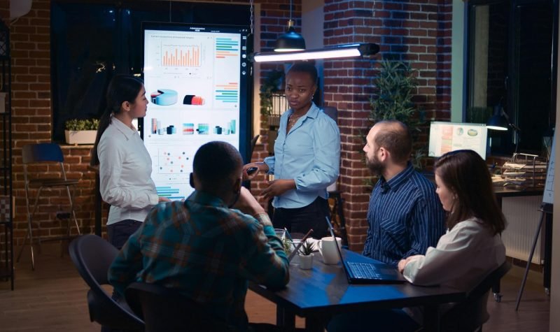 Diverse women coaching company team in business meeting